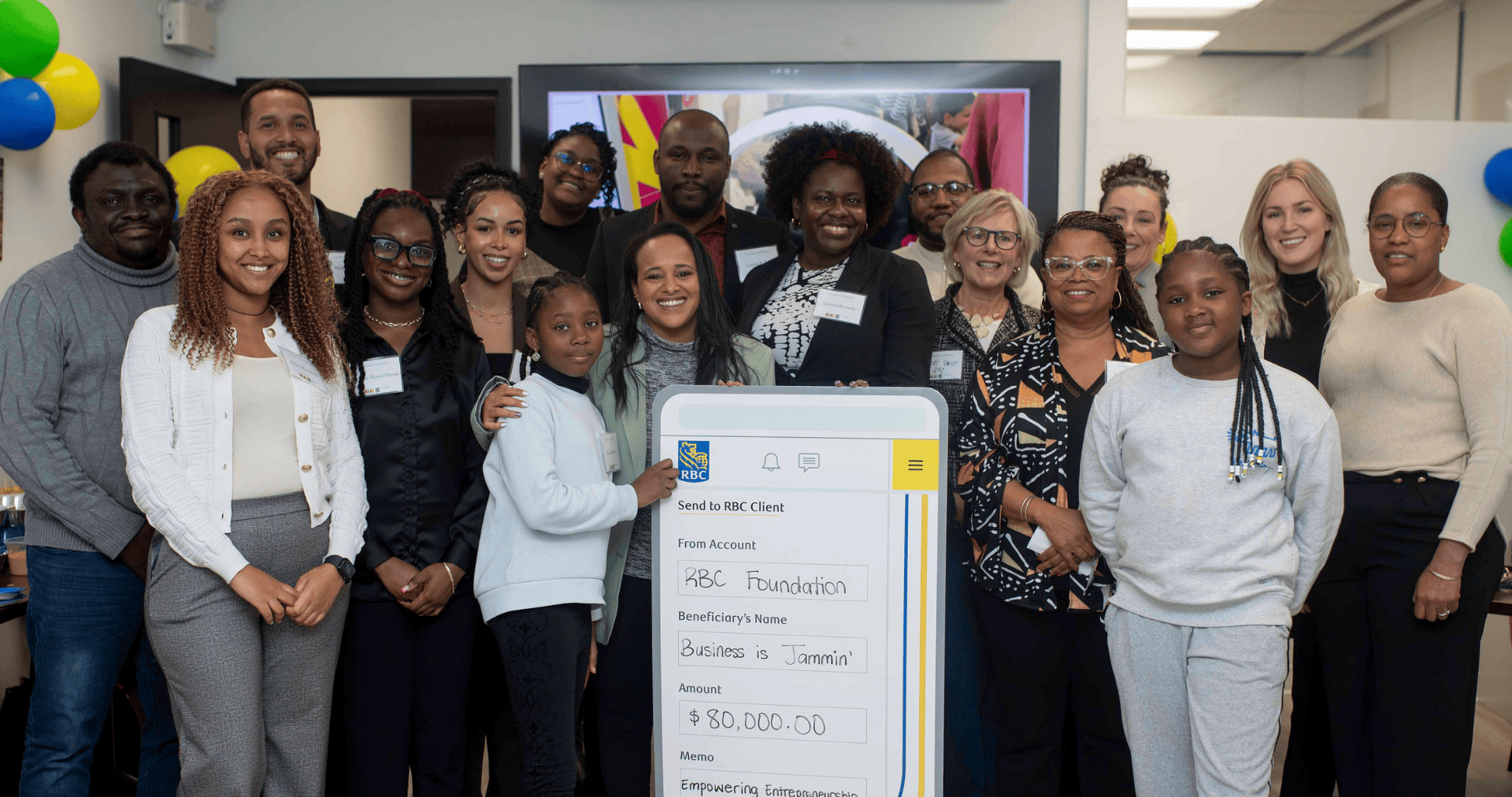 A group of youth and adults receiving a funding donation