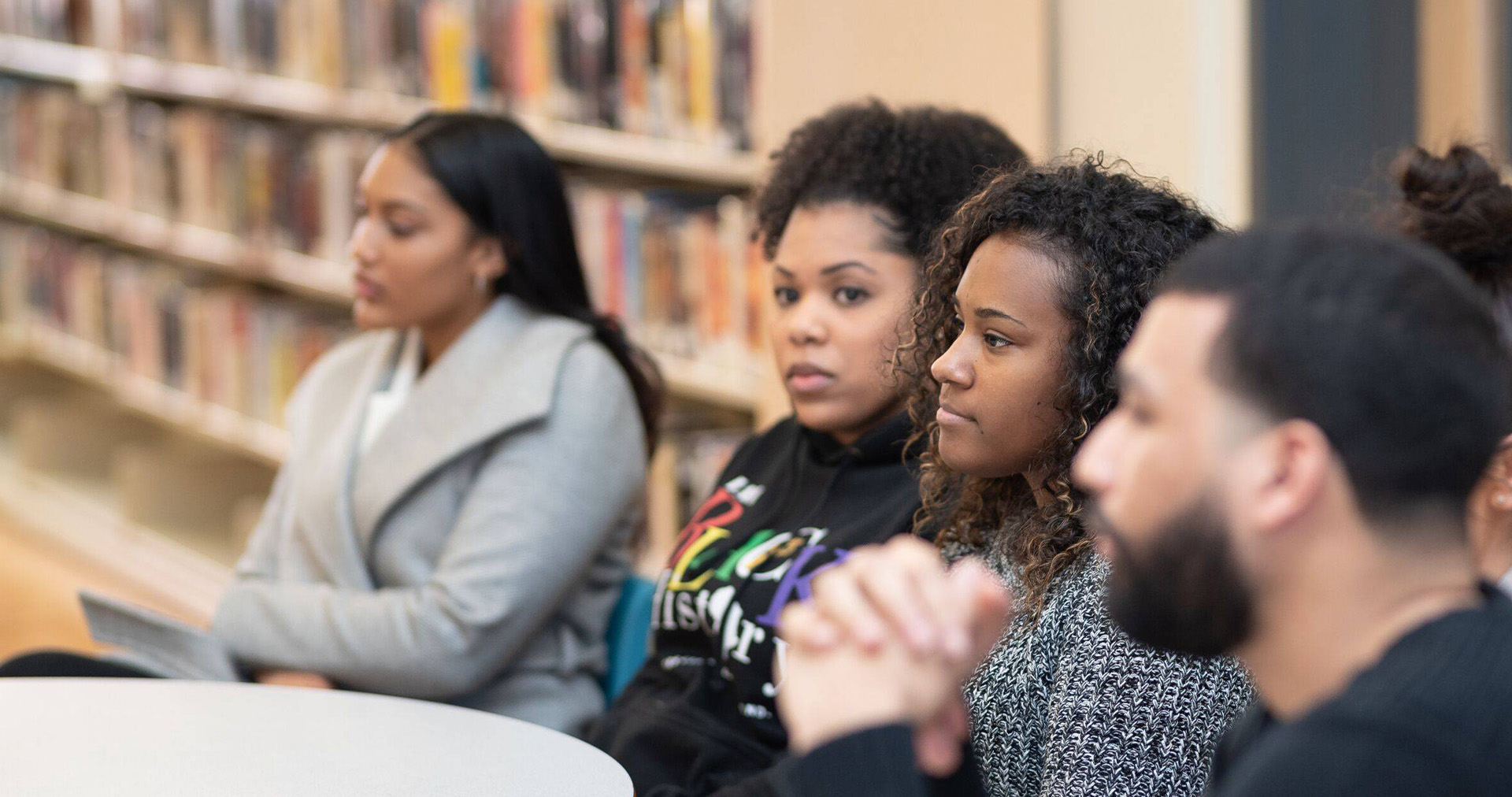 Group of youth sitting at a table listening